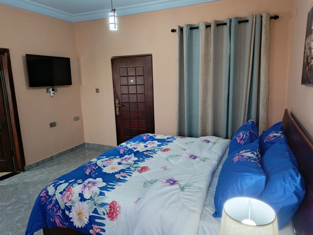 Luxury Premium Plus room with private balcony access and coffee set at Green Apple Hotel Ghana.