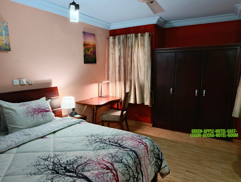 Green Apple Hotel room East Legon Accra — spacious modern room with dedicated workspace desk and flat screen TV. hotels in East Legon Accra